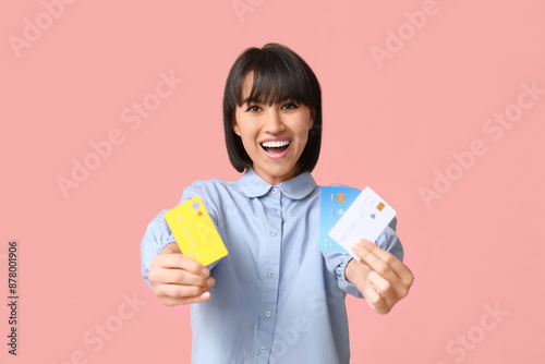 Happy young woman with cred...