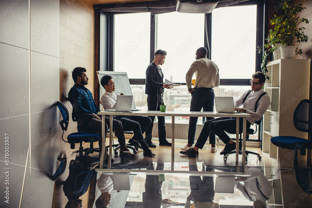 Panoramic picture of multiracial group of people meeting in modern spacious office interior with a panoramic window Panoramic picture of multiracial group of people meeting in modern spacious office interior with a panoramic window