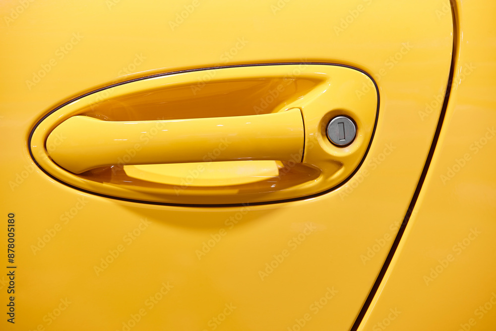 Car door handle detail in yellow color. Automotive industry.
