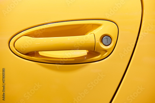 Obraz na płótnie Car door handle detail in yellow color. Automotive industry. w salonie