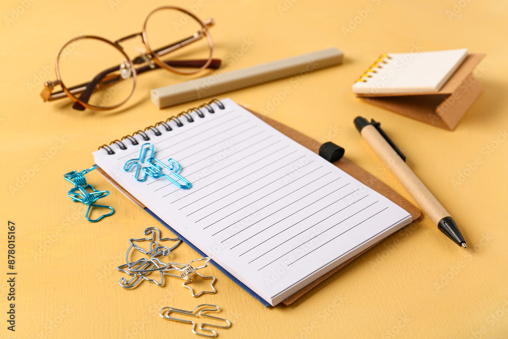 School stationery and glasses on orange background School stationery and glasses on orange background