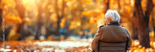 National Senior Citizens Day. Horizontal banner. An elderly gray-haired man sits on a bench in an autumn park. Copy space. The problem of loneliness in older people. Care for the elderly concept photo