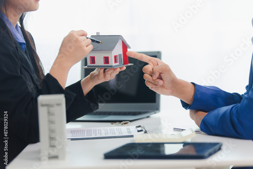 Businessman, house and condo sales representative Hand over the keys to the customer and sign the sales or rental contract according to mutual agreement in the office. Real estate business concept photo