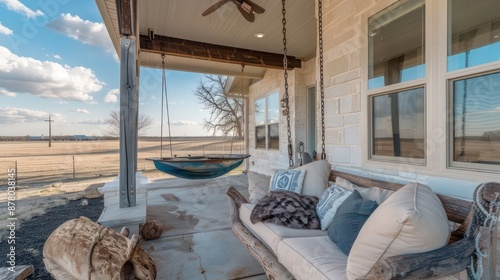 ranch house with a front porch that includes a swing made from repurposed boat wood, adding a nautical theme to the home