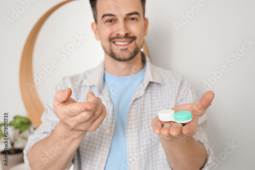 Young man with contact lens...