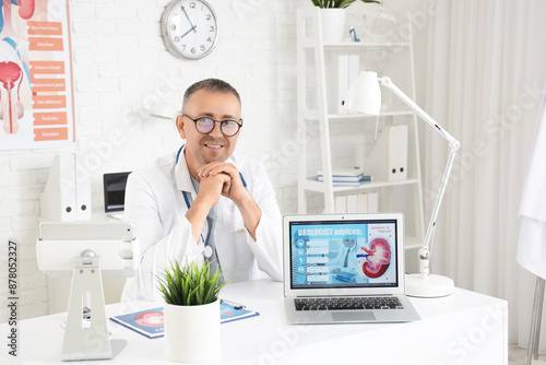 Male urologist with laptop ...