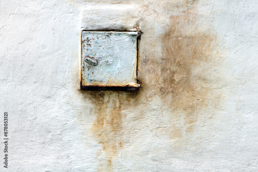Iron door for cleaning ash and soot of the old stove. The door is in the old wall. Iron door for cleaning ash and soot of the old stove. The door is in the old wall.