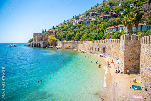 Fototapeta Naklejka Na Ścianę i Meble -  Ancient shipyard or Tersane near of Kizil Kule tower and beautiful beach and calm turquoise sea surface in Alanya, Turkey