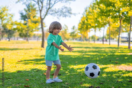 Smiling Boy with Football in Nature