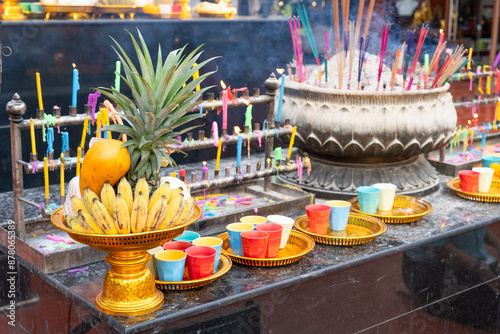 Offerings of bananas, pineapples, and milk in plastic cups that Buddhists bring to offer to the highly revered Lord Ganesha, enshrined at the Bang Yai Temple, Nonthaburi, Thailand. photo