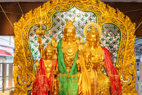 The bronze statues of Lord Shiva, Uma Devi and Ganesha are highly revered by many Buddhists. They often come to pay their respects here at Bang Yai Temple, Nonthaburi, Thailand. photo