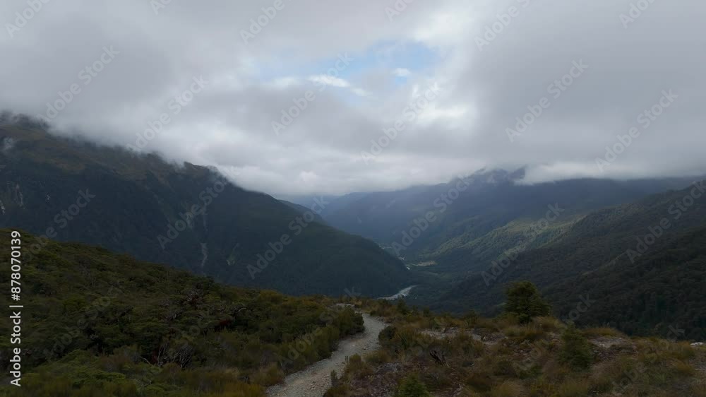 Pov hike on key summit trail of mountains in Fiordland Nationalpark. Cloudy day with green scenery in New Zealand. Pov hike on key summit trail of mountains in Fiordland Nationalpark. Cloudy day with green scenery in New Zealand.