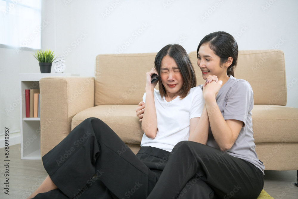 Lesbian girls chatting on the couch, playing games, watching TV together. Show affection for each other by hugging and holding hands. Happy couple hugging and laughing, LGBT relationship concept Lesbian girls chatting on the couch, playing games, watching TV together. Show affection for each other by hugging and holding hands. Happy couple hugging and laughing, LGBT relationship concept