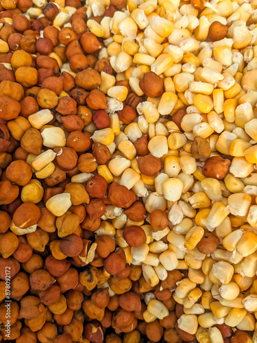 pile of black chickpeas and corn seeds mix, close up food background