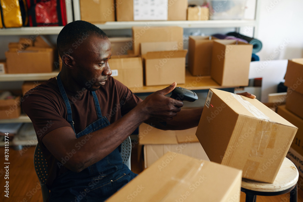 African American worker scanning barcode on order before shipment African American worker scanning barcode on order before shipment