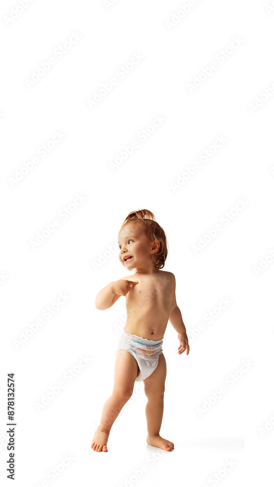 Happy, smiling baby girl in diaper standing isolated on white background. Active and healthy. Vertical image. Concept of childhood, care, health, infancy, lifestyle, motherhood Happy, smiling baby girl in diaper standing isolated on white background. Active and healthy. Vertical image. Concept of childhood, care, health, infancy, lifestyle, motherhood