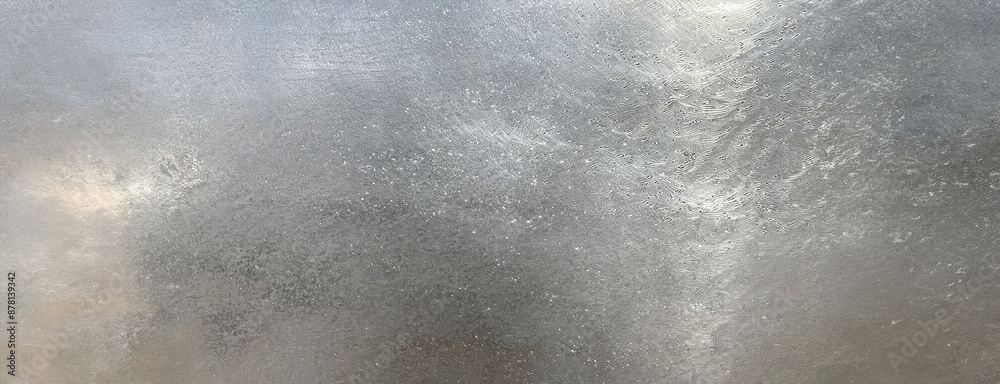 A textured background of polished silver, abstract and sleek in appearance.