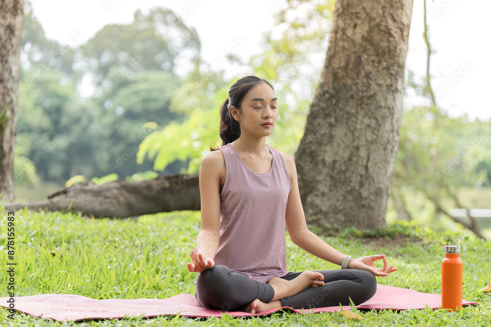 Woman Practicing Yoga and Relaxing in a Serene Park Setting with Lush Greenery and Trees Woman Practicing Yoga and Relaxing in a Serene Park Setting with Lush Greenery and Trees
