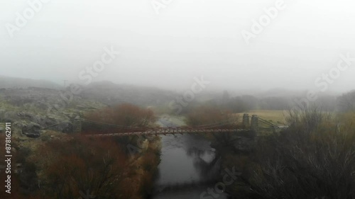 Flyover up Manuherikia River looking down on historic Daniel O'Connell Bridge near to Ophir town in Central Otago. photo