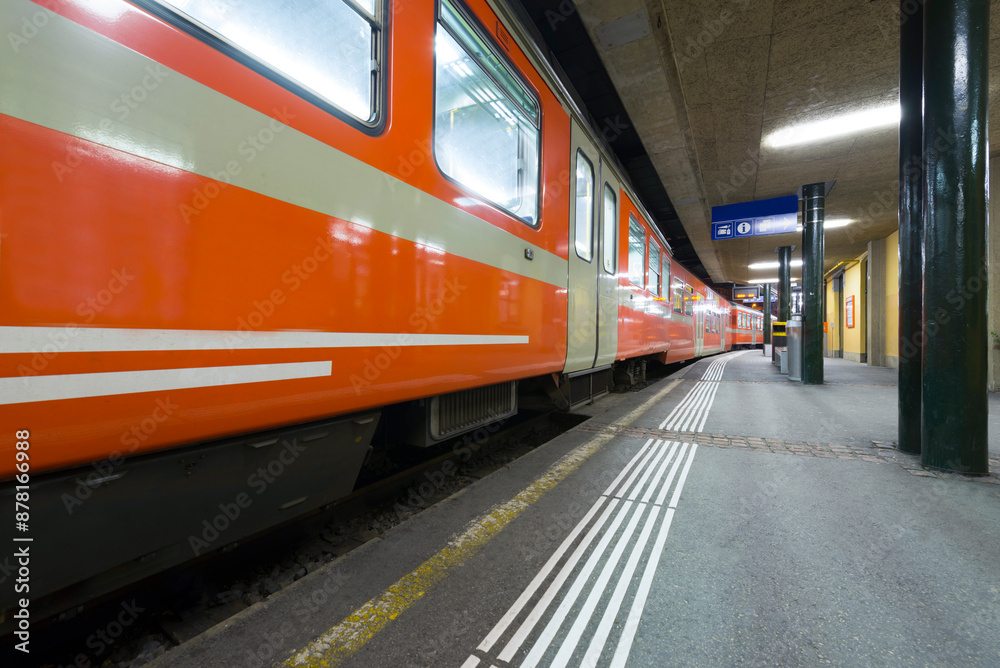Obraz premium Railroad Station and a Train at night in Lugano, Ticino, Switzerland.