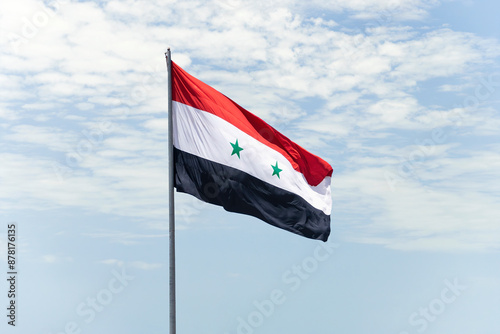 Flag on syria flag pole and blue sky, Flag of The Syrian Arab Republic fluttering in blue sky national symbol. Waving white Yemen flag, Independence Constitution Day. photo