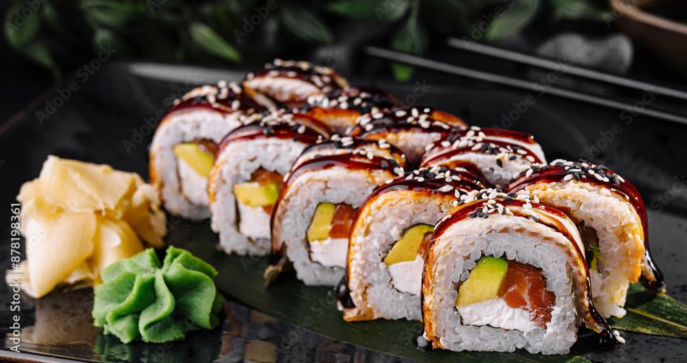 Exquisite sushi roll platter on elegant dark background Exquisite sushi roll platter on elegant dark background