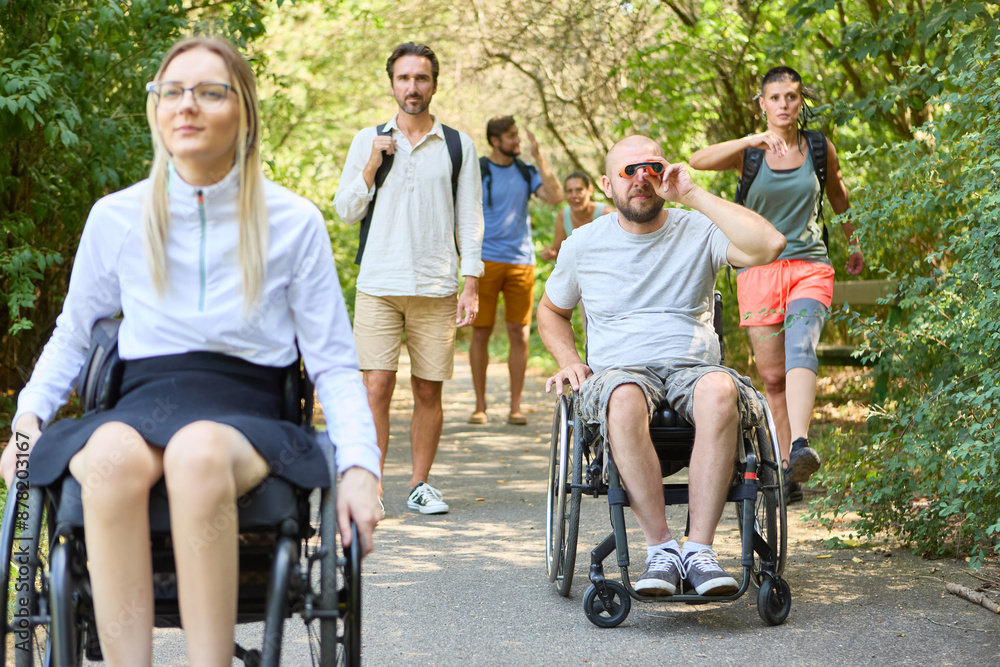 People with mobility disabilities enjoying a day at the park with friends People with mobility disabilities enjoying a day at the park with friends