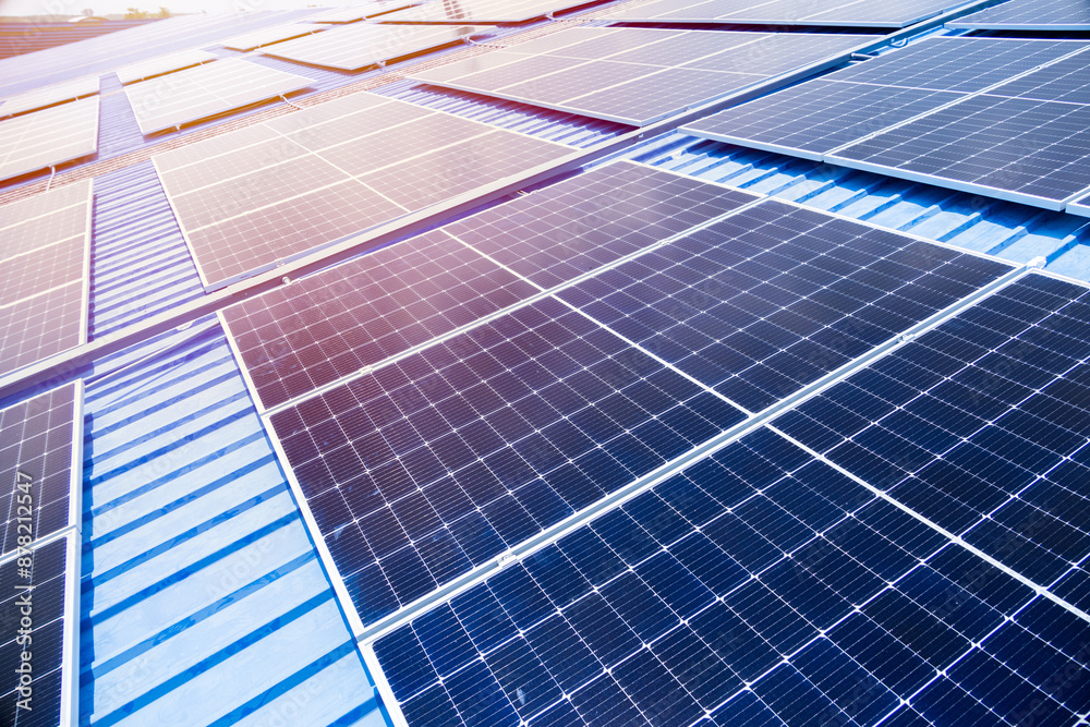 Large Photovoltaic panels on industry roof . Grid view of Solar panels or Solar cell in the factory roof house for saving energy background. Large Photovoltaic panels on industry roof . Grid view of Solar panels or Solar cell in the factory roof house for saving energy background.