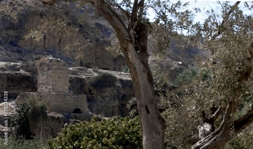 An old dilapidated house and mill next to a valley in a mountainous area