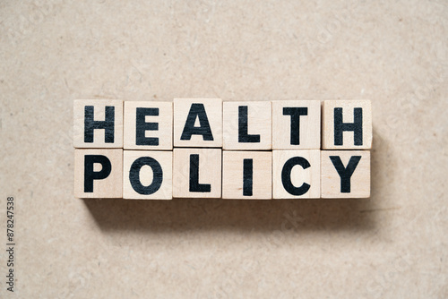 Alphabet letter block in word health policy on wood background