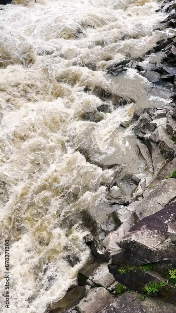 Stormy streams of water and cascades of mountain river waterfalls. Vertical video. Stormy streams of water and cascades of mountain river waterfalls. Vertical video.