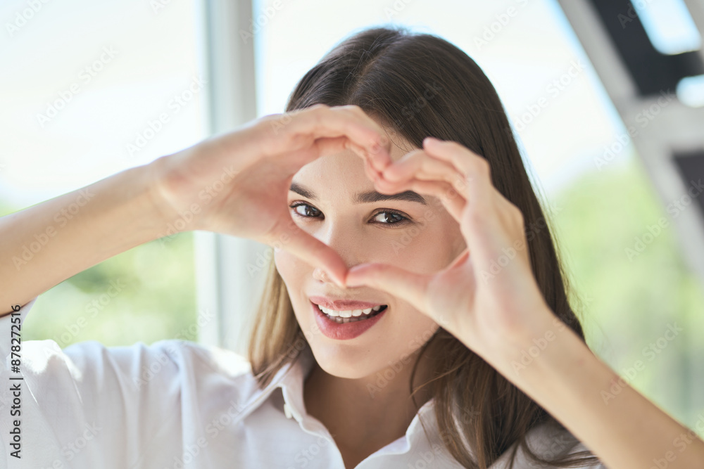 Eye Care. Young Woman Making Heart Shape With Hands, Smiling Cheerfully. Concept Of Love, Positivity, And Happiness.