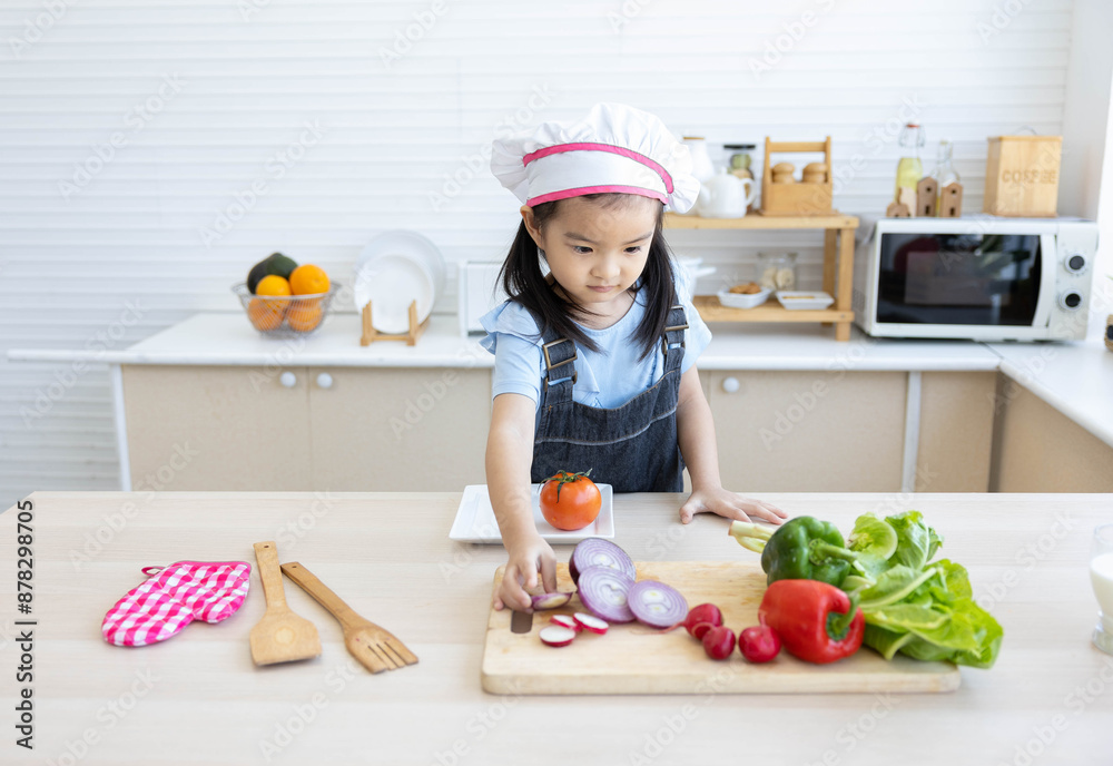 asian kid cooking and preparing vegetables meal in the kitchen asian kid cooking and preparing vegetables meal in the kitchen