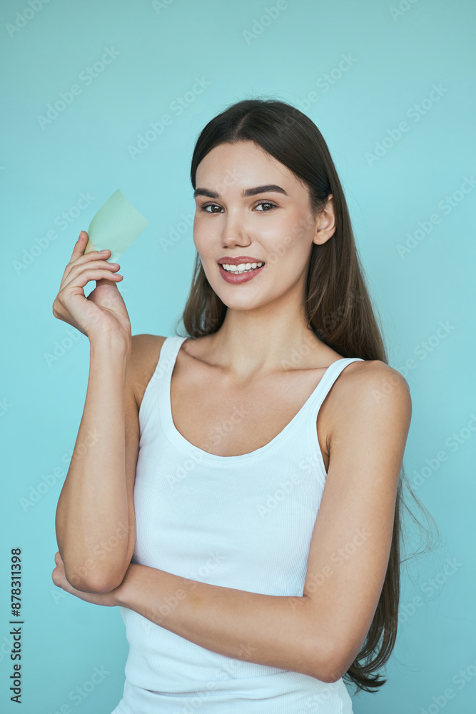 Woman With Skincare Product Against Blue Background. Natural Beauty, Self-Care, And Wellness Concept Woman With Skincare Product Against Blue Background. Natural Beauty, Self-Care, And Wellness Concept