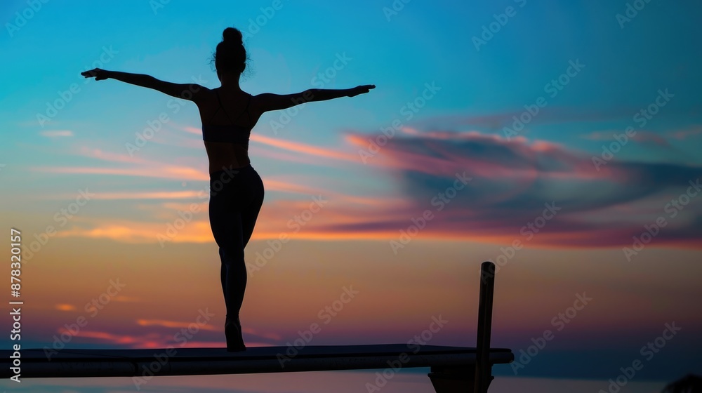 Silhouette of Gymnast Balancing on Beam in Dramatic Lighting. Silhouette of Gymnast Balancing on Beam in Dramatic Lighting.