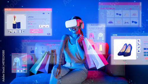 Smart female sitting on sofa while wearing VR headset connecting metaverse, future cyberspace community technology. Elegant woman enjoy opening online store menu shop luxury product. Hallucination.