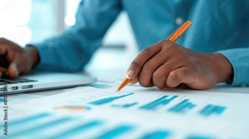 Businessman analyzing financial data and making notes Businessman analyzing financial data and making notes