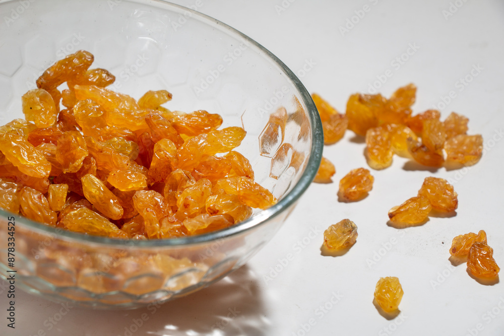 closeup Yellow raisins in open glass bowl, isolated on white closeup Yellow raisins in open glass bowl, isolated on white
