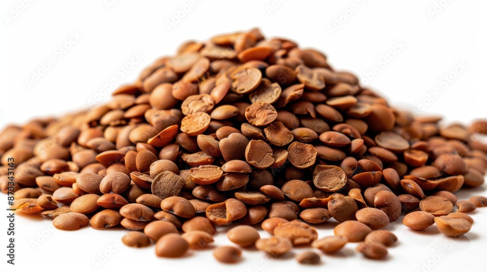 A pile of brown lentils isolated on a white background. A pile of brown lentils isolated on a white background.