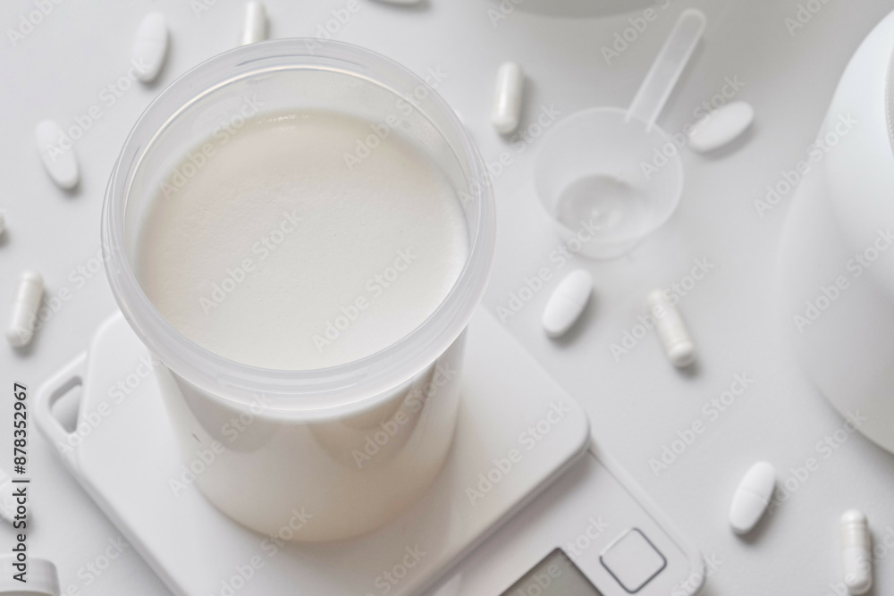 Whey protein and supplements on white background. Whey protein and supplements on white background.