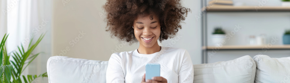 Joyful woman relaxing on sofa while using smartphone Joyful woman relaxing on sofa while using smartphone