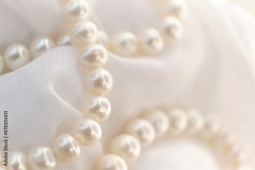 A poetic arrangement of pearls lays on a soft canvas, the blurring effect adding a touch of mystery. The scene encourages a slow, thoughtful appreciation in a fast-scrolling digital world.