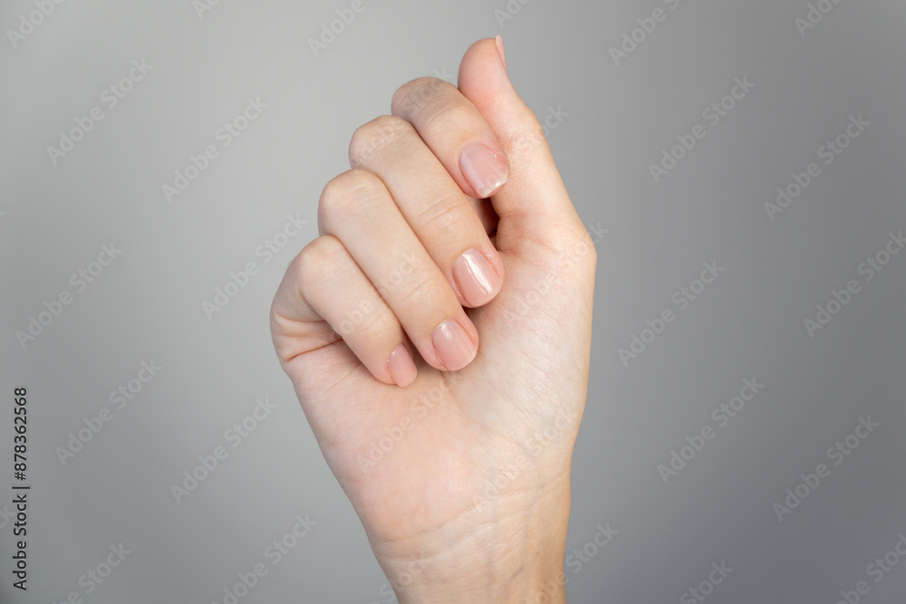 Close-up of woman's hands with neutral manicure. Showcasing natural Close-up of woman's hands with neutral manicure. Showcasing natural