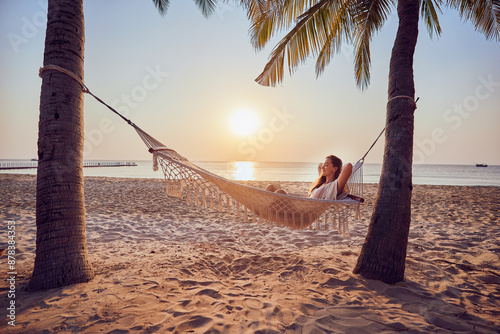 Canvastavla Young carefree inspired nomad woman with hands behind head relaxing in a hammock