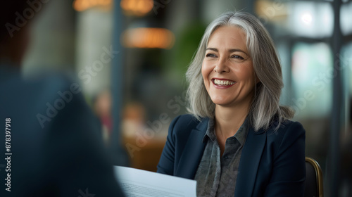 Woman and man in business attire sit at table