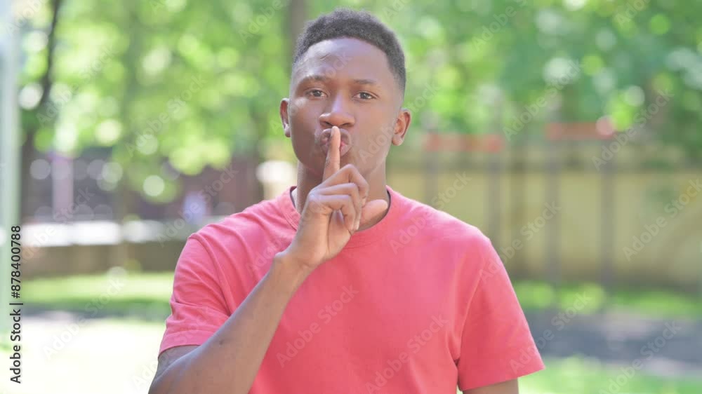 Keep the Secret Gesture by Casual African Man Standing Outdoor
