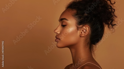 captivating portrait of latina beauty side profile of young woman with flawless skin and striking features against warm brown backdrop soft lighting enhances natural beauty and cultural pride