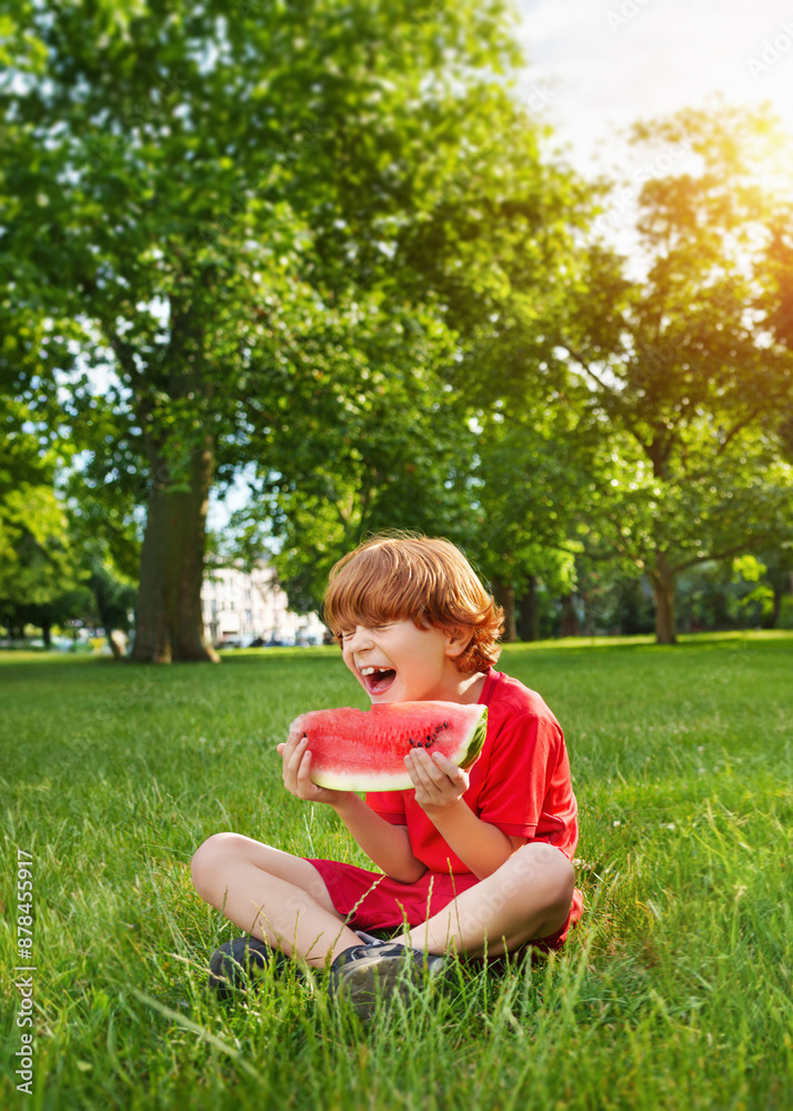 A happy smiling child in summer with watermelon in his hand. Juicy refreshment outside. A happy smiling child in summer with watermelon in his hand. Juicy refreshment outside.