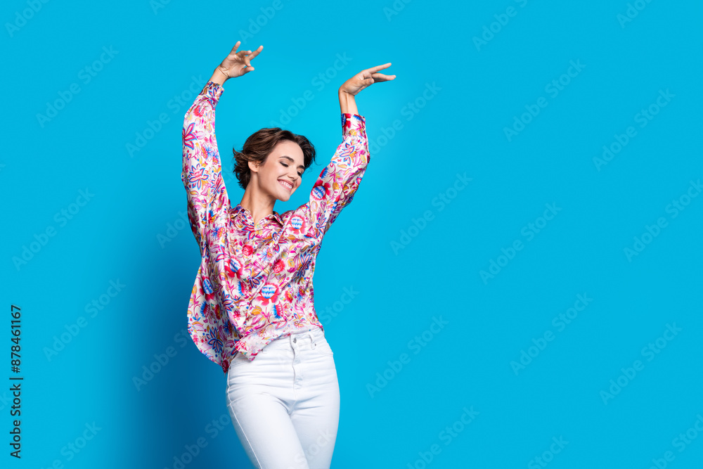 Portrait of positive nice person raise arms dancing partying empty space ad isolated on blue color background Portrait of positive nice person raise arms dancing partying empty space ad isolated on blue color background
