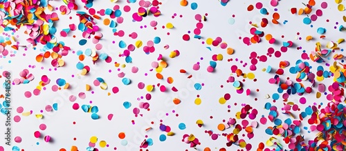 Confetti in various colors falling against a white backdrop symbolizes a festive atmosphere for a copy space image.